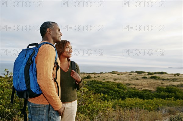 Black couple overlooking rural hillside