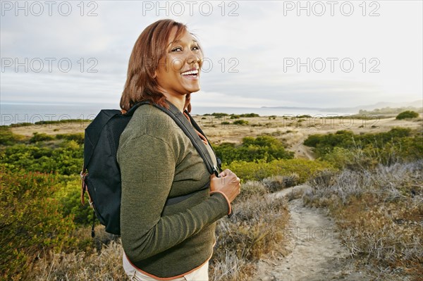 Black woman hiking on rural path