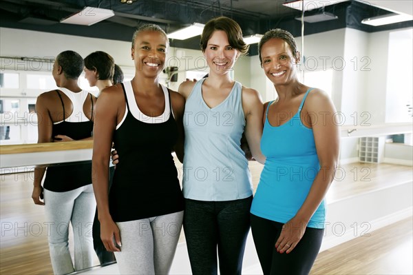 Women smiling together in yoga studio