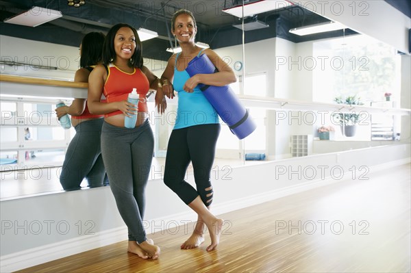 Women smiling together in yoga studio