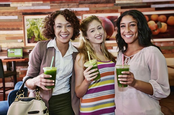 Women having juice together in cafe