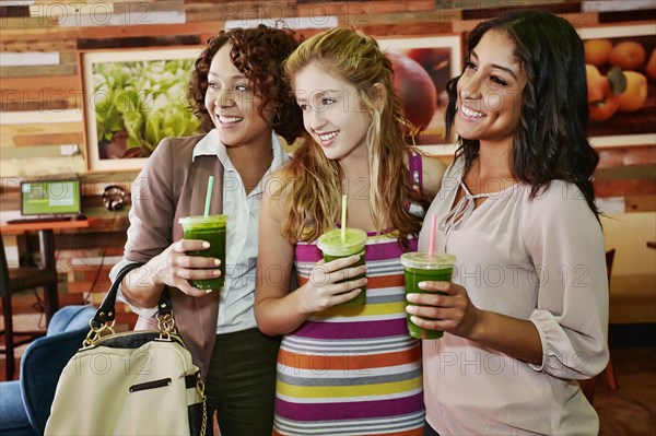 Women having juice together in cafe