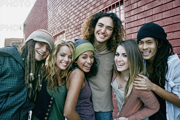 Friends smiling together on city street