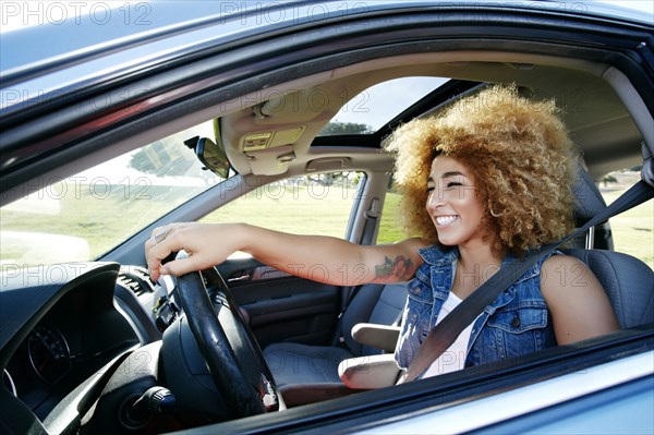 Hispanic woman driving car