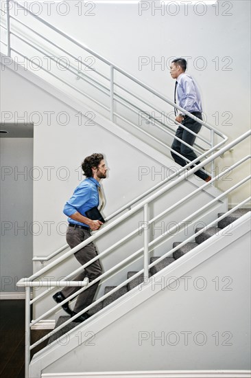 Businessmen climbing staircase