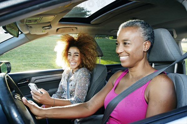 Mother and daughter driving car