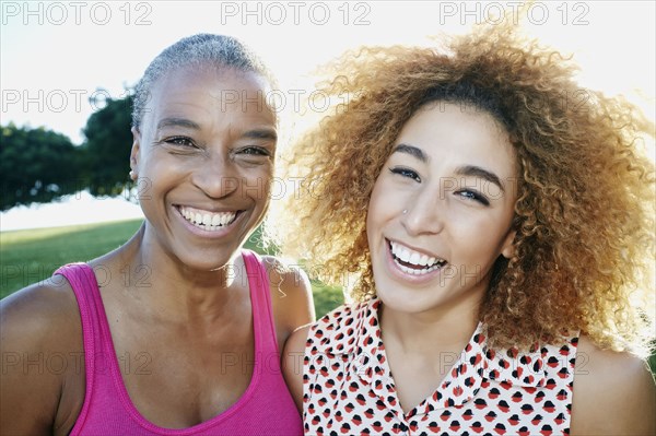 Mother and daughter smiling outdoors