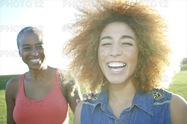 Mother and daughter smiling outdoors