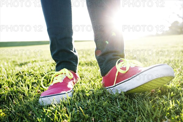 Close up of Hispanic woman's sneakers