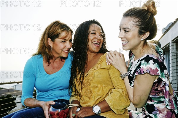 Women relaxing together at waterfront