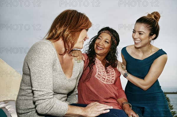 Women relaxing together at waterfront