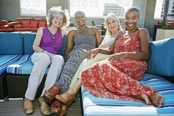 Women relaxing together on urban rooftop