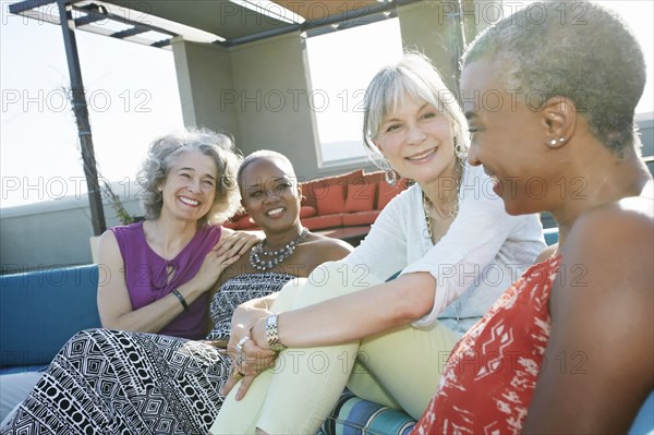 Women relaxing together on urban rooftop
