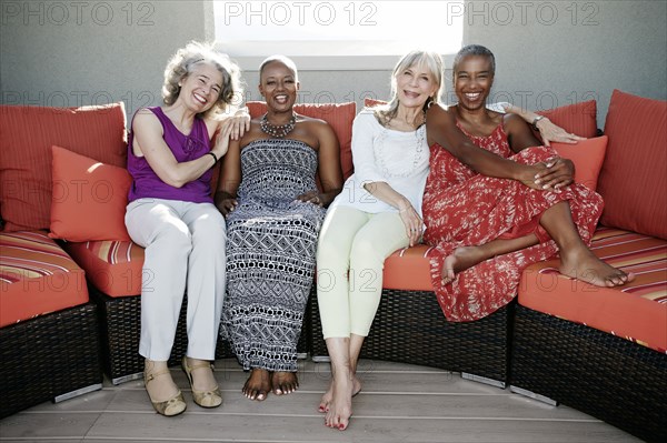 Women relaxing together on urban rooftop