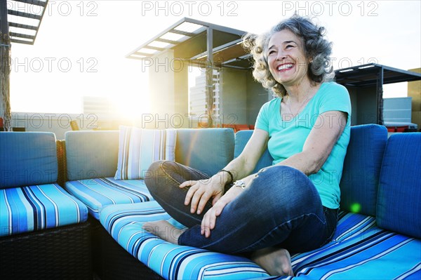 Caucasian woman relaxing on urban rooftop