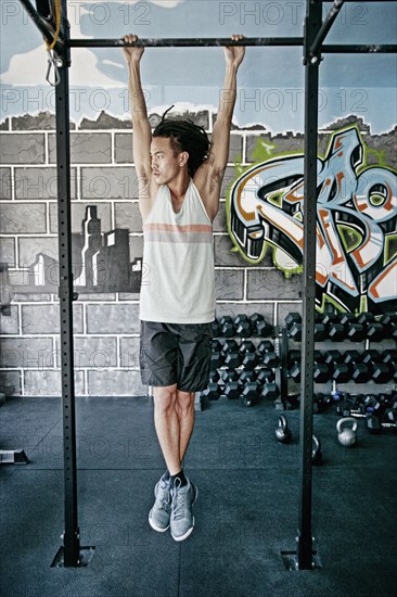 Asian man exercising in gym