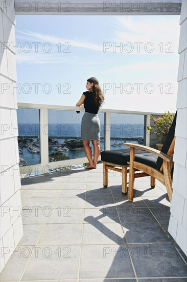 Mixed race woman admiring scenic view from balcony