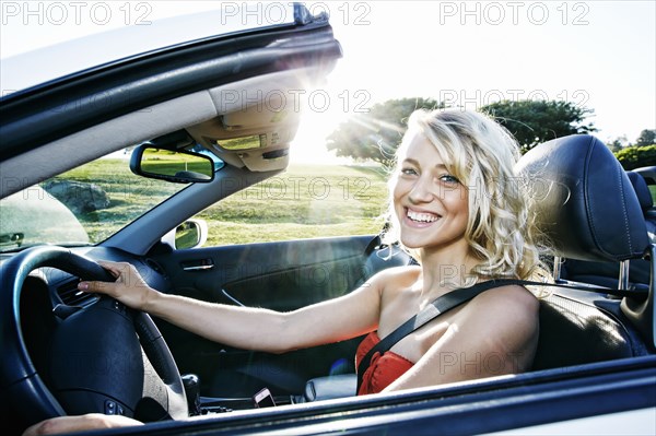 Caucasian woman driving convertible