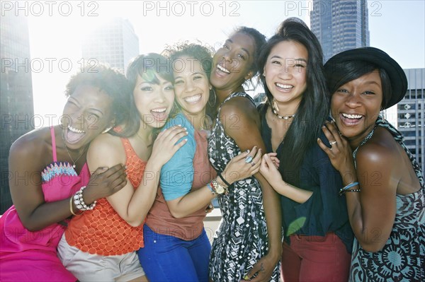 Women hugging on urban rooftop