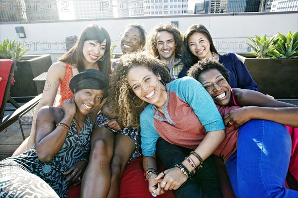 Friends hugging on urban rooftop