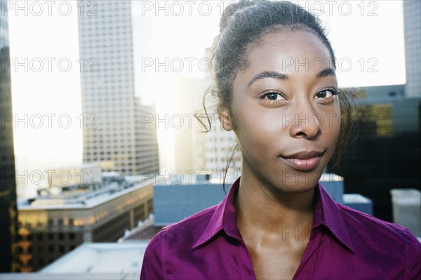 African American woman smiling on urban rooftop