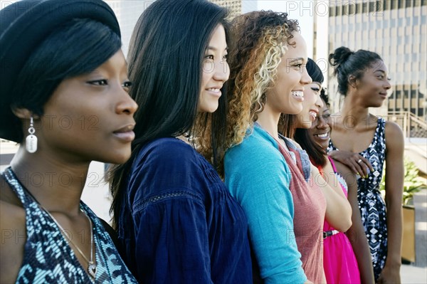 Women smiling on urban rooftop