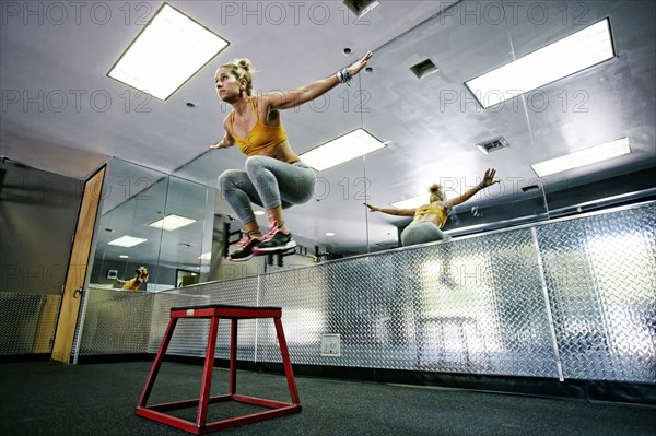 Caucasian woman working out in gym