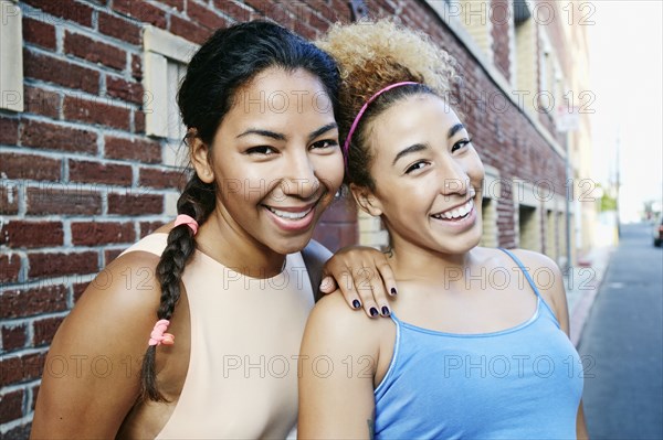 Hispanic women smiling in city