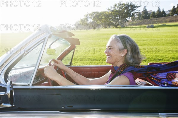 Caucasian woman driving classic convertible