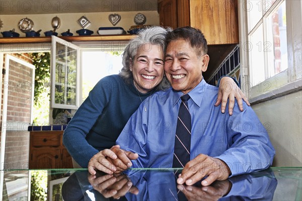 Couple smiling in kitchen