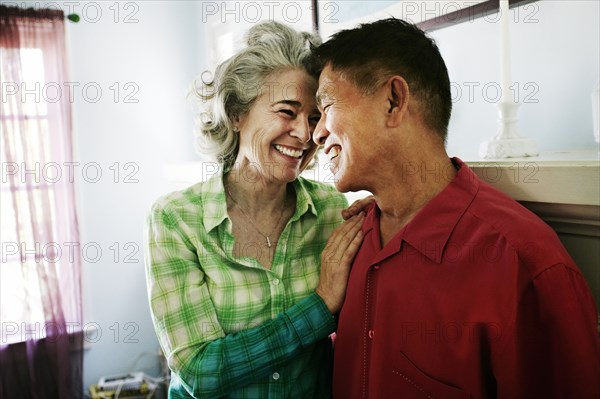 Smiling couple hugging in living room