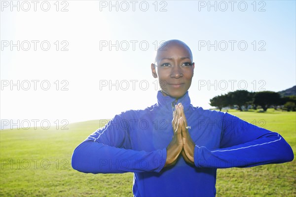 African American woman meditating in park
