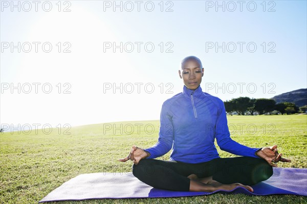 African American woman meditating in park