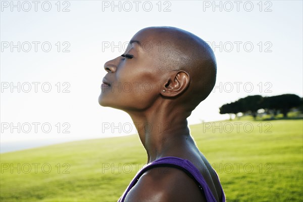 Profile of African American woman smiling in park