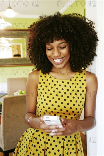 Mixed race woman using cell phone