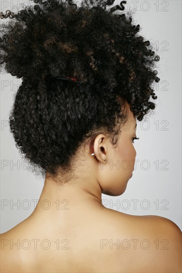 Rear view of mixed race woman looking over shoulder