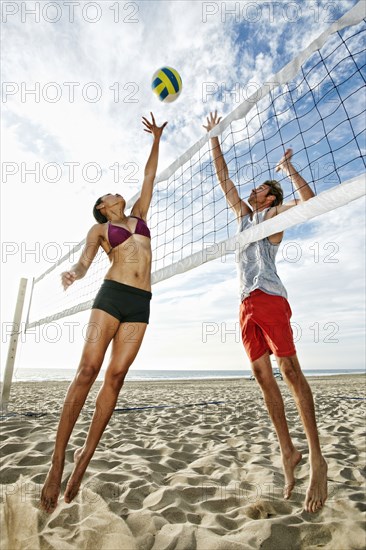 Friends playing volleyball on beach