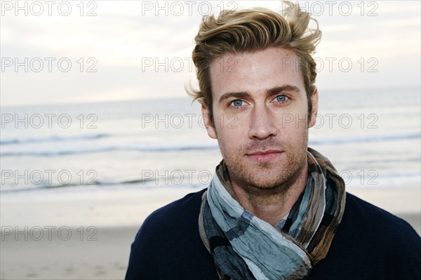 Caucasian man standing on beach