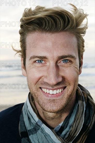 Caucasian man smiling on beach