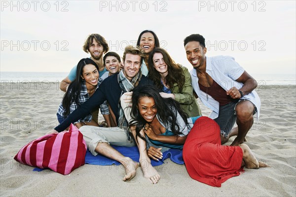 Smiling friends posing on beach