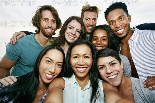 Smiling friends taking selfie outdoors