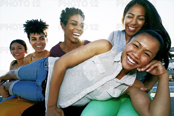 Women smiling on urban rooftop