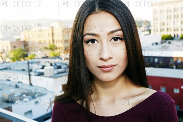 Mixed race woman standing on urban rooftop