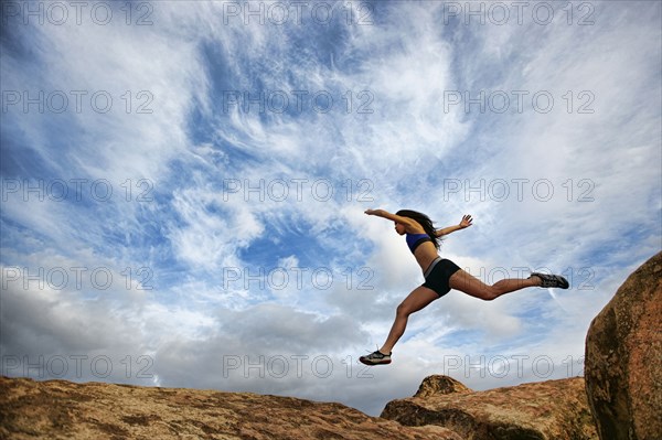 Vietnamese woman running in rocky field