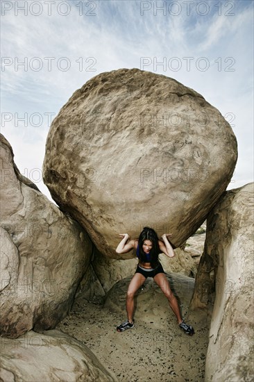 Vietnamese athlete lifting boulder