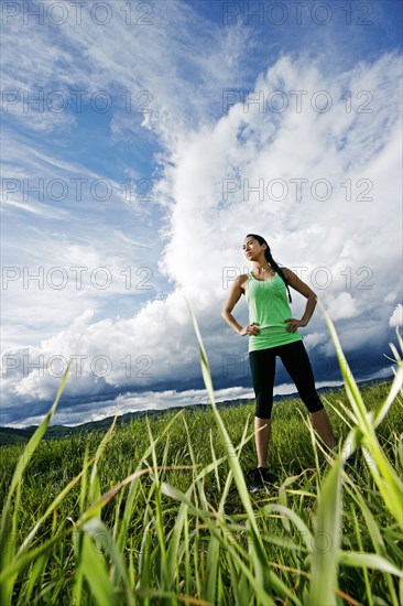 Mixed race athlete standing in rural field