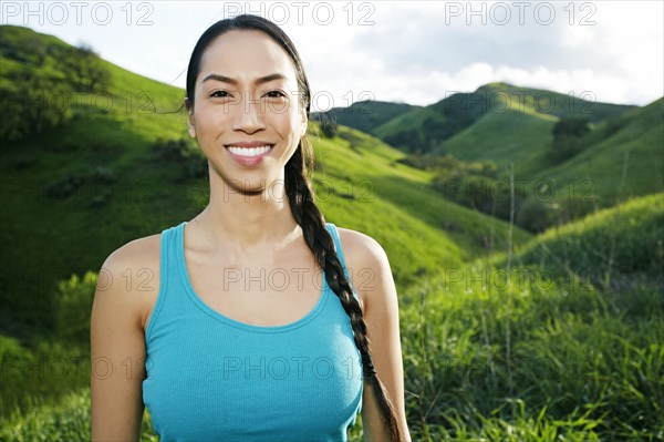 Mixed race athlete standing on rural hillside