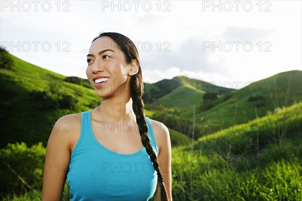 Mixed race athlete standing on rural hillside