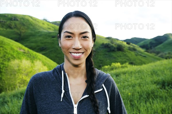 Mixed race athlete standing on rural hillside