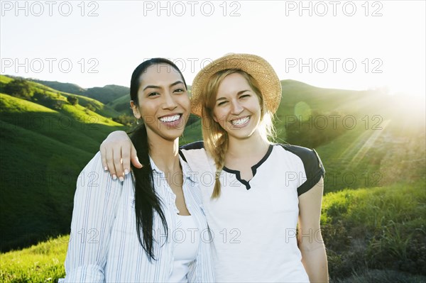 Women smiling on rural hilltop